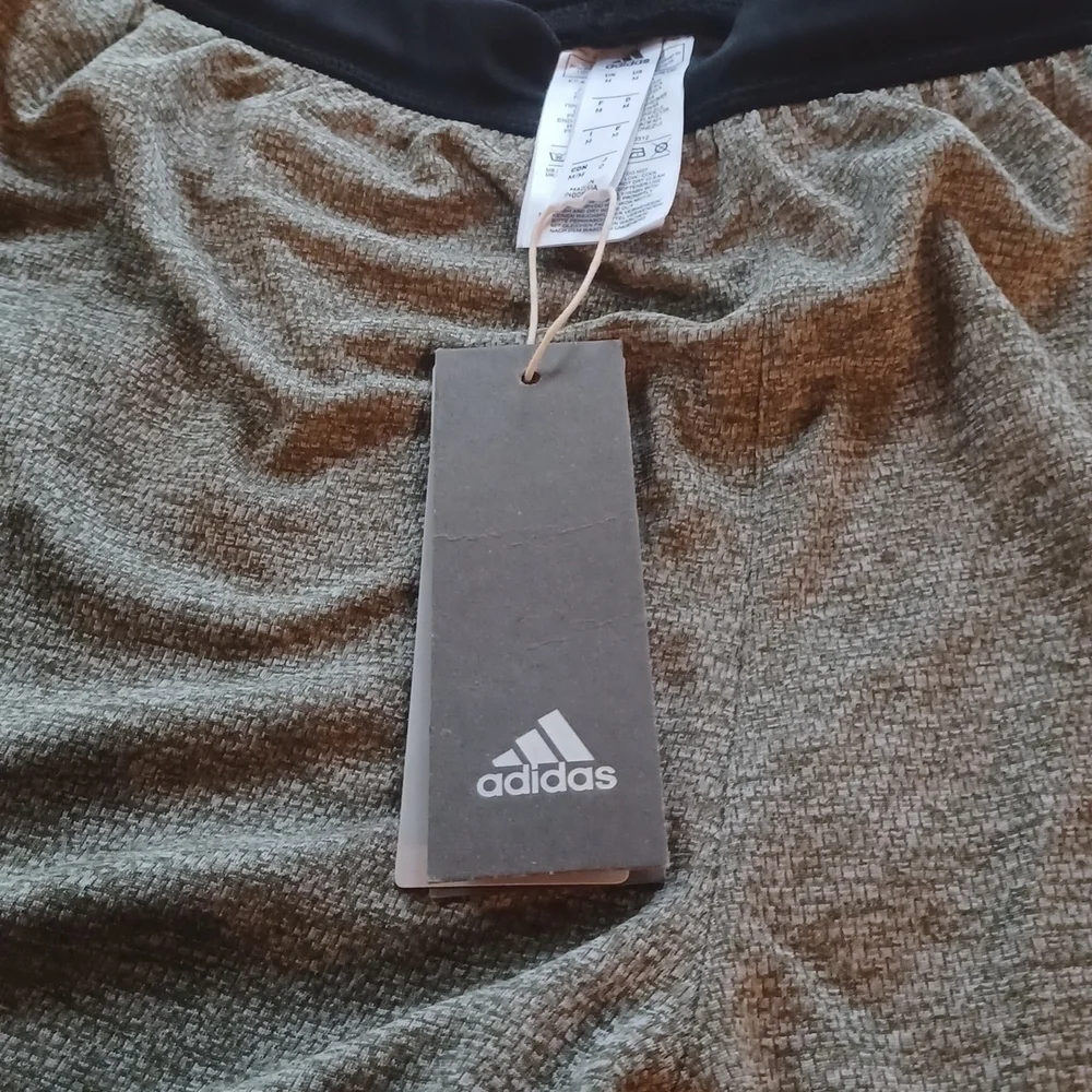 NWT   Adidas knit Grey shorts. Black waist band, white stripes. Size medium.